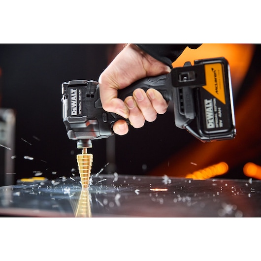 DEWALT x McLaren F1 Team 18V XR Special Edition Impact Driver with 4Ah battery drilling metal sheeting with a step drill bit