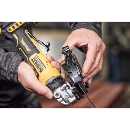 Cutting guard being attached to the DEWALT 18V XR Compact 125mm Angle Grinder
