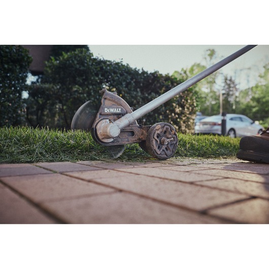 Close view of the DEWALT 54V XR FLEXVOLT Straight Shaft Edger trimming lawn edge
