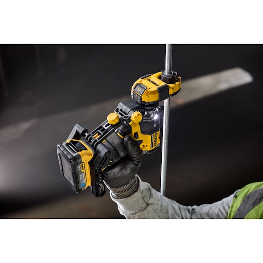 Worker using Dewalt Nut Runner Attachment to thread rod