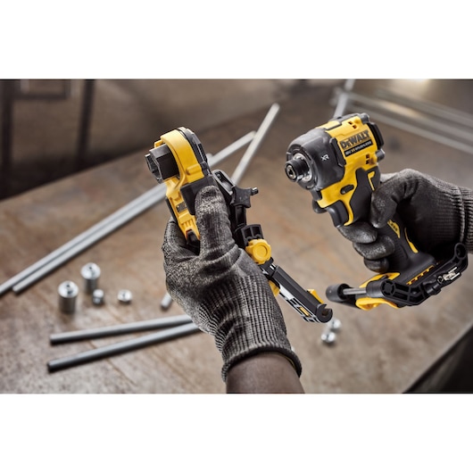 User attaching Dewalt Nut Runner Attachment to impact driver