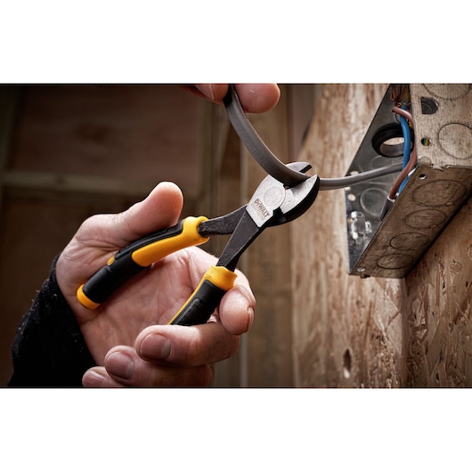 DEWALT LH Diag plier 160mm being used to cut cables