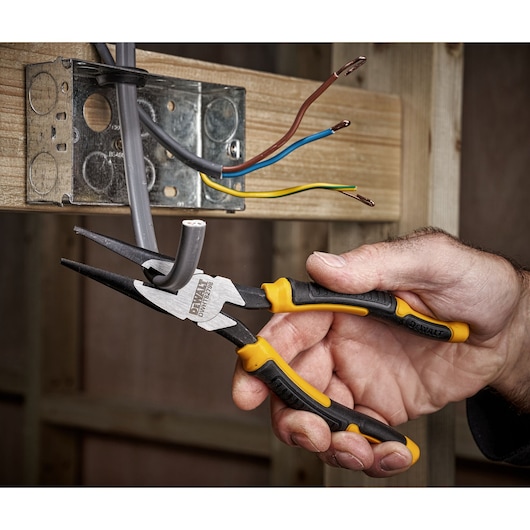 DEWALT 8" LH Long Nose 200mm plier being used to cut cable on socket"
